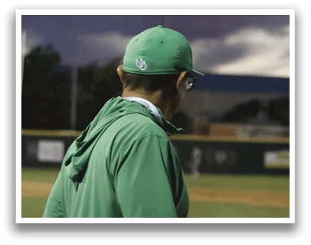 A man wearing a green shirt and a green hat. Description generated by AI