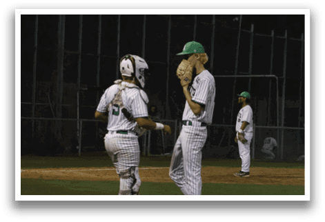 A baseball player wearing a green hat. Description generated by AI