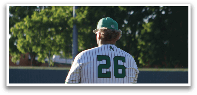 A baseball player wearing a green and white uniform. Description generated by AI