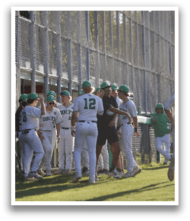 A group of baseball players wearing green and white uniforms. Description generated by AI
