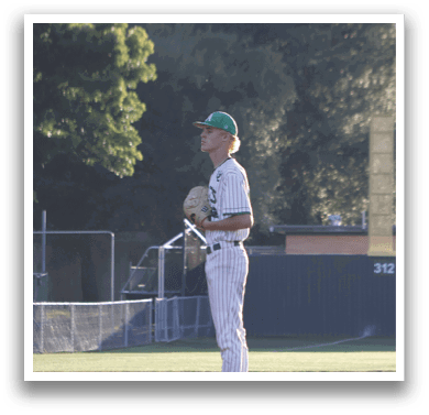 A baseball player is standing on the field holding a mitt. Description generated by AI