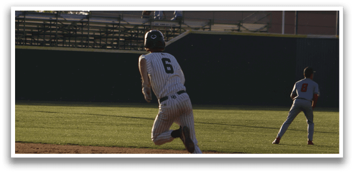 A baseball player is running to a base. Description generated by AI