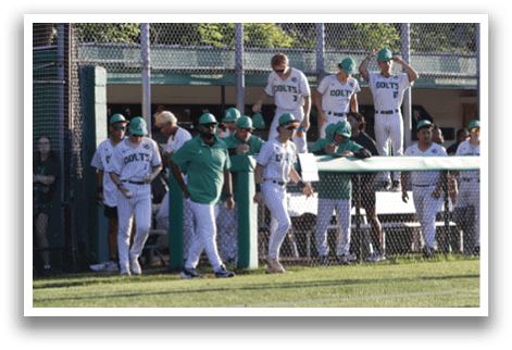 A group of people standing on a baseball field. Description generated by AI