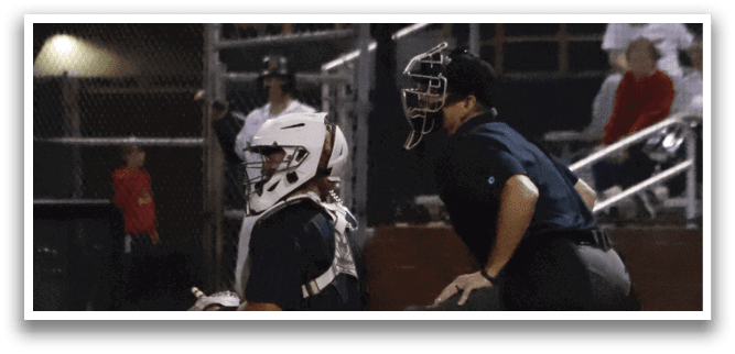 A baseball player is holding a bat, ready to swing. Description generated by AI