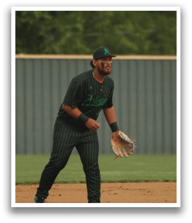 A baseball player wearing a black and green uniform. Description generated by AI