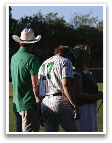 A man and woman standing on a baseball field. Description generated by AI