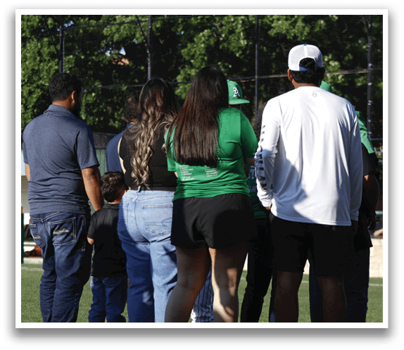 A group of people standing on a field. Description generated by AI