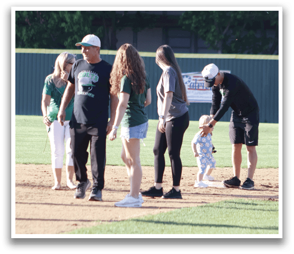 A group of baseball players standing in a line. Description generated by AI