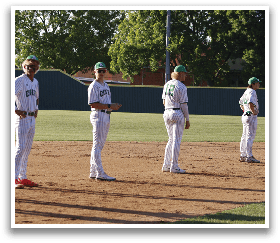 A group of baseball players standing in a line. Description generated by AI