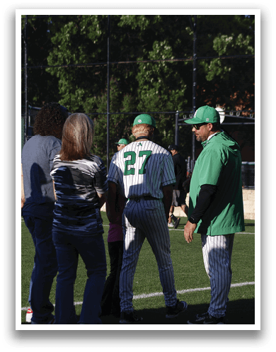 A man and woman standing on a baseball field. Description generated by AI
