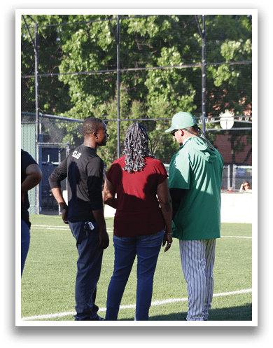A man wearing a baseball uniform walks on a field. Description generated by AI