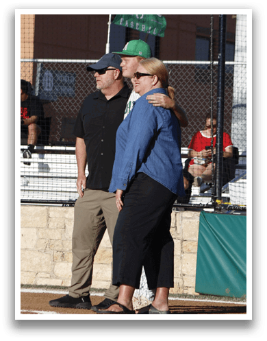 A man and woman standing on a baseball field. Description generated by AI