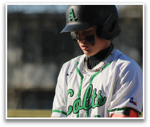 A baseball player wearing a green and white jersey. Description generated by AI