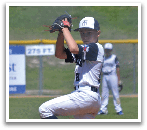 A baseball player in a white uniform is pitching a ball. Description generated by AI