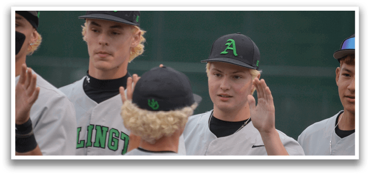 A group of baseball players wearing white and green uniforms. Description generated by AI