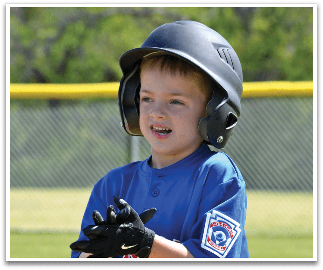 A young boy wearing a blue baseball uniform and a black helmet. Description generated by AI