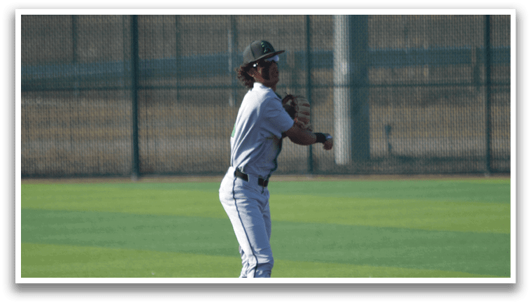 A baseball player in a grey uniform is standing on the field, holding a baseball bat and preparing to swing. AI generated content
