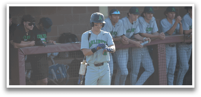 A baseball player wearing a helmet and a green shirt stands on a field. AI generated content