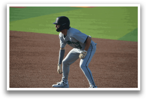 A baseball player in a green and black uniform is standing on the field, holding a baseball glove. AI generated content