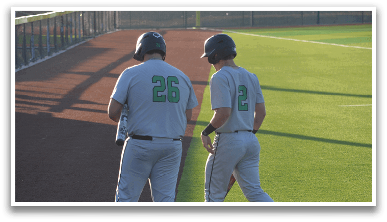Two baseball players wearing grey uniforms walk on the field. AI generated content