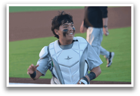 A baseball player wearing a white uniform and a black helmet with a smudge of paint on his face. AI generated content
