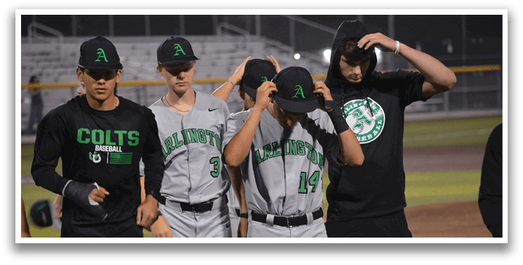A group of baseball players wearing grey and black uniforms are walking on a field. AI generated content