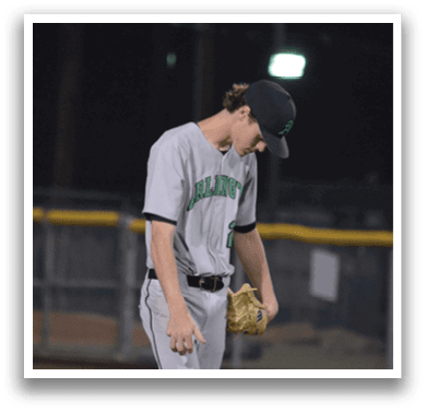 A baseball player in a grey uniform is holding a baseball in his right hand. AI generated content