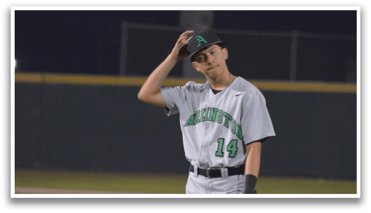 A baseball player wearing a green and white uniform stands on the field, holding a baseball glove. AI generated content