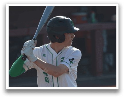 A baseball player in a green and white uniform is holding a bat, preparing to swing. AI generated content