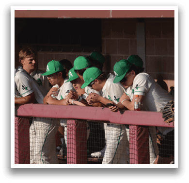A group of baseball players wearing green hats and white uniforms are sitting on a bench. AI generated content