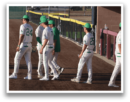 A group of baseball players wearing green hats and white uniforms are walking down a dirt road. AI generated content