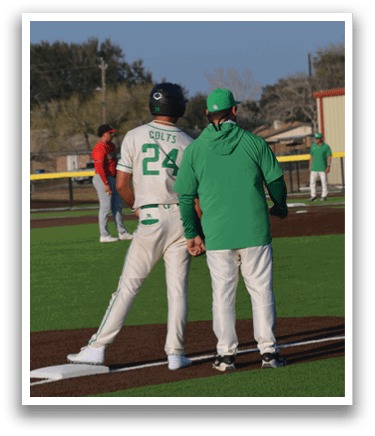 Two baseball players wearing green and white uniforms are talking to each other on the field. AI generated content