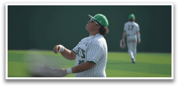 A baseball player in a green hat and white uniform is throwing a ball. AI generated content
