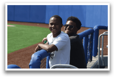 Two men are standing on a baseball field, one of them wearing sunglasses. AI generated content