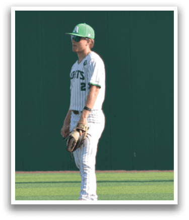 A baseball player wearing a white uniform stands on a green field. AI generated content