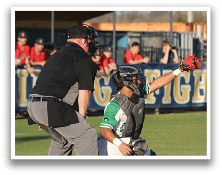 A baseball player is holding up his glove, ready to catch the ball. The catcher is kneeling behind him, wearing a baseball glove as well. The scene takes place on a baseball field, with several other people present in the background. AI generated content