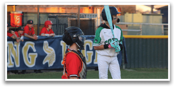 A boy in a baseball uniform is holding a bat, standing next to a catcher. AI generated content