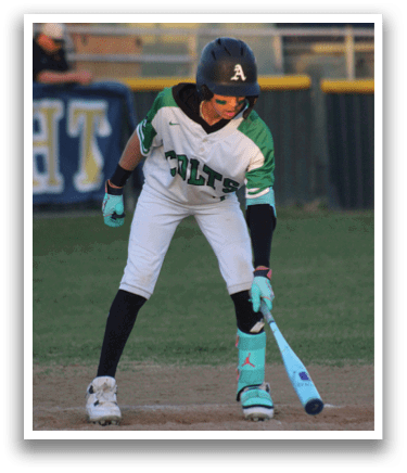 A baseball player in a white and green jersey is holding a bat and getting ready to hit a ball. AI generated content