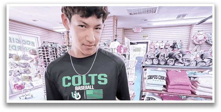 A young man wearing a black shirt with a green C on it is holding a package of toothbrushes. AI generated content