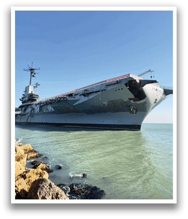 A large navy ship is docked at a pier. AI generated content