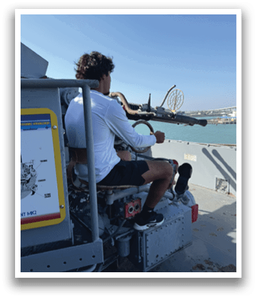 A man is sitting in a chair on a boat, holding a gun. AI generated content