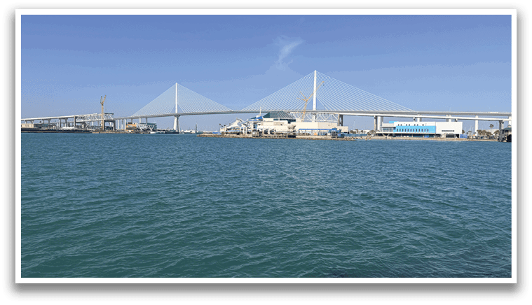 A large body of water with a bridge crossing over it. AI generated content