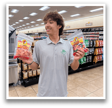 A man in a grocery store holding two packages of food. AI generated content