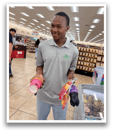 A man in a grocery store holding a pink cup and a bag of chips. AI generated content