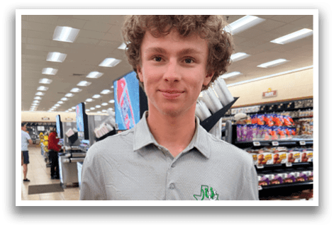A man holding a bag of candy and a bottle of soda in a grocery store. AI generated content