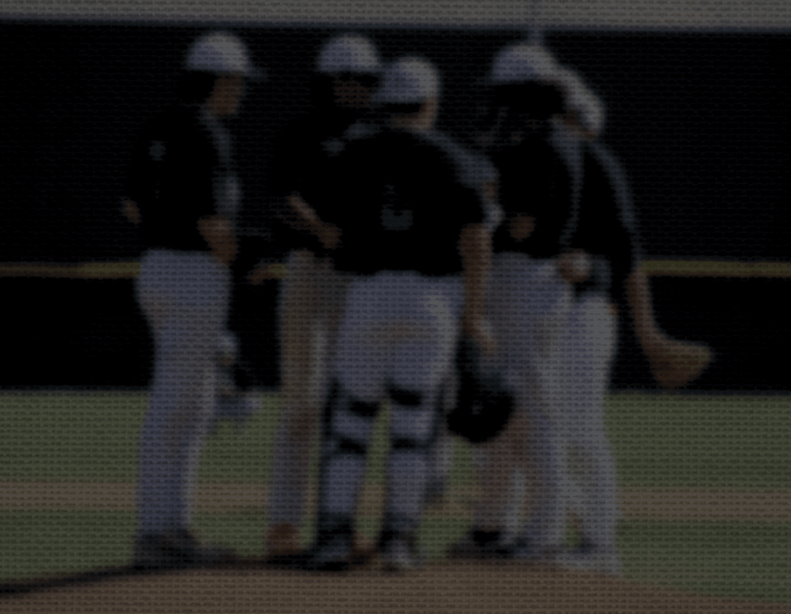 A group of baseball players wearing black and white uniforms are standing on a field. They are engaged in a conversation, possibly discussing their game strategy. AI generated content
