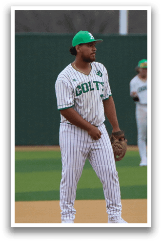 A baseball player wearing a green hat and a white and green striped uniform stands on a baseball field. AI generated content