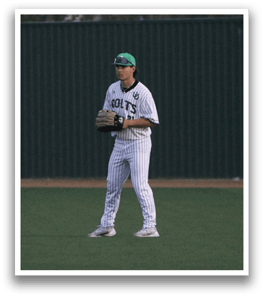A baseball player in a white uniform stands on a field, holding a mitt. AI generated content
