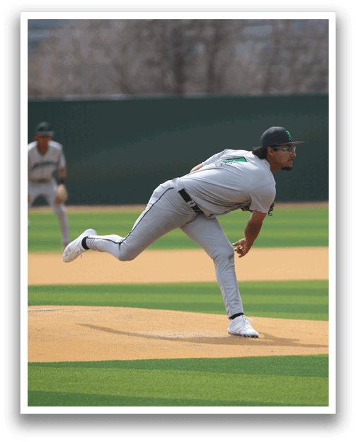 A baseball player in a grey uniform is pitching a ball on a field. AI generated content