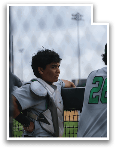 A baseball player wearing a white uniform and a catcher's mitt is leaning on a fence. AI generated content